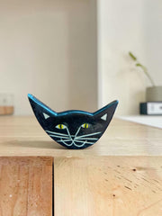 Spilla in ceramica a forma di gatto nero con occhi espressivi, dipinta a mano, circa 3 × 4 cm